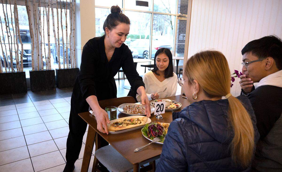 Owner Sofiya Gulaliyeva serves the Caldona family of Kent, (from left) daughter Denice, mom Jenny, and son LJ, at Lezzet Brunch in Auburn on Thursday, Jan. 12, 2023.