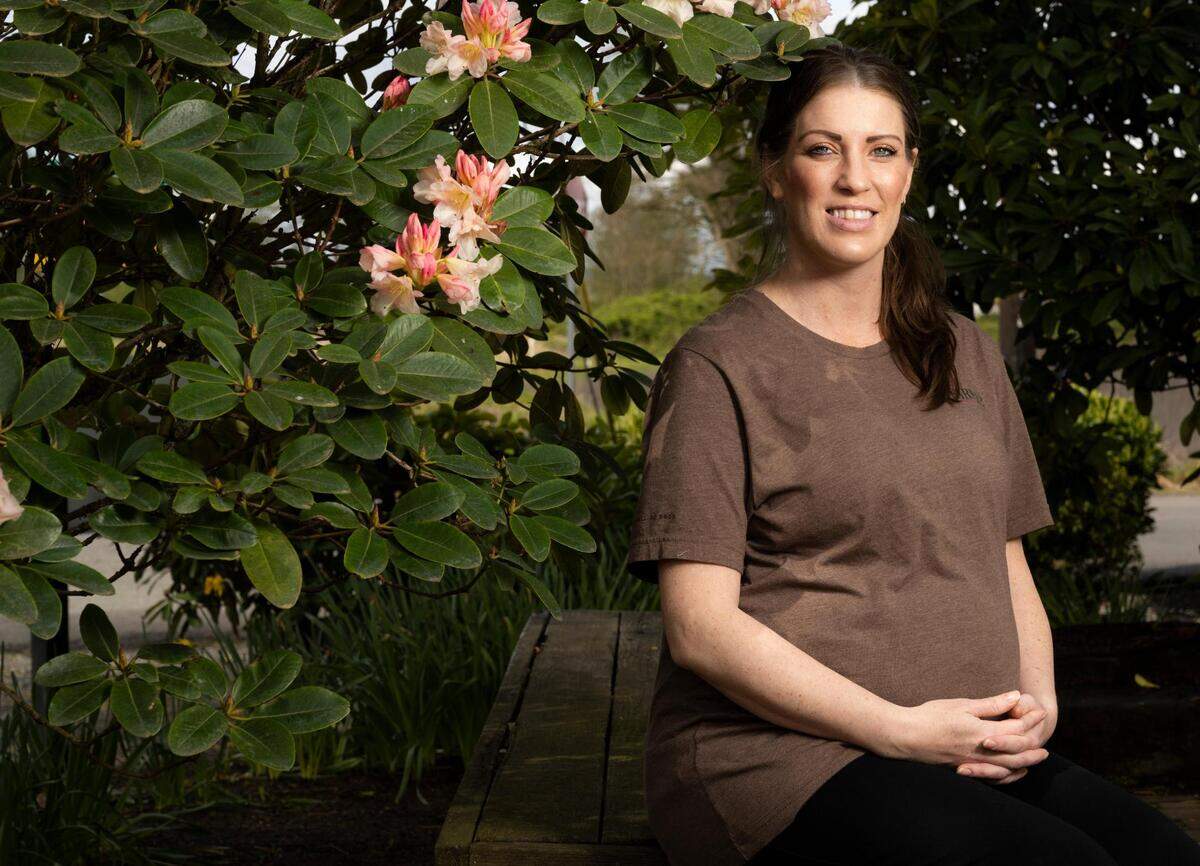 Jowell Scott, a server at Farm12 and single mom of four children with her fifth on the way, poses for a portrait at Farm12 on Thursday, April 21, 2022 in Puyallup, Wash.