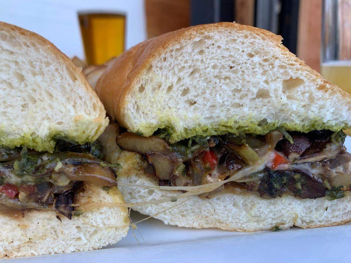 The fried green tomato sandwich at Harmon Pac Ave in Tacoma, Wash., packs a savory punch with a medley of sautéed vegetables.