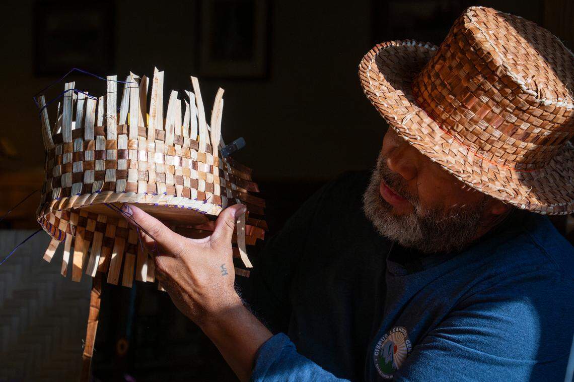 Hweqwidi Hanford McCloud, a Nisqually tribal member and a liaison for the Nisqually Tribal Council, shares his insights as a master weaver, pointing out the parts of an in-progress graduation hat woven out of cedar bark on Friday, June 6, 2025, at the National Park Inn at Mount Rainier National Park.