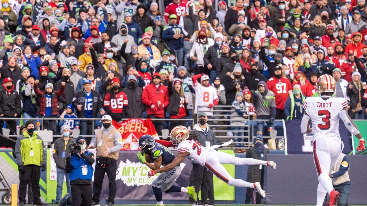 Seattle Seahawks wide receiver Tyler Lockett (16) pulls in a touchdown pass from quarterback Russell Wilson (3) as San Francisco 49ers cornerback Josh Norman (26) defends during the third quarter of an NFL game on Sunday at Lumen Field in Seattle.