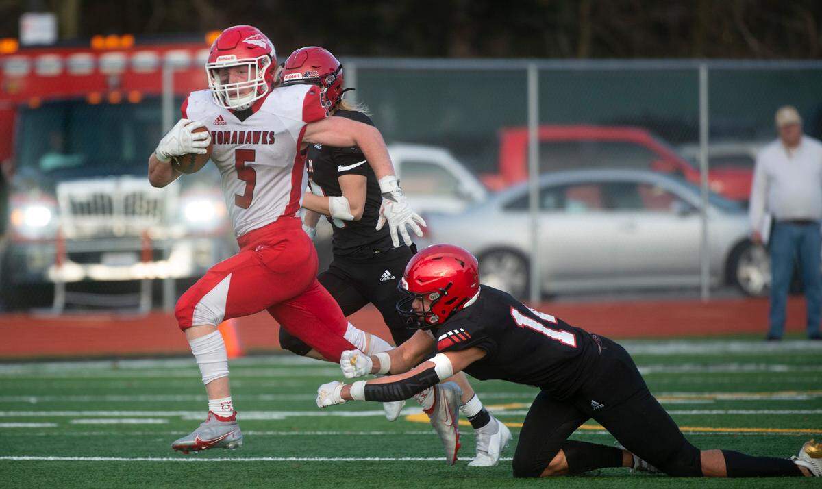 Marysville-Pilchuck running back Dylan Carson creaks away from Yelm defensive back Marius Alone for a touchdown run during Saturday afternoon’s 3A football state quarterfinal game at Yelm High School in Yelm, Washington, on Nov. 20, 2021. Marysville-Pilchuck won the game, 39-21.