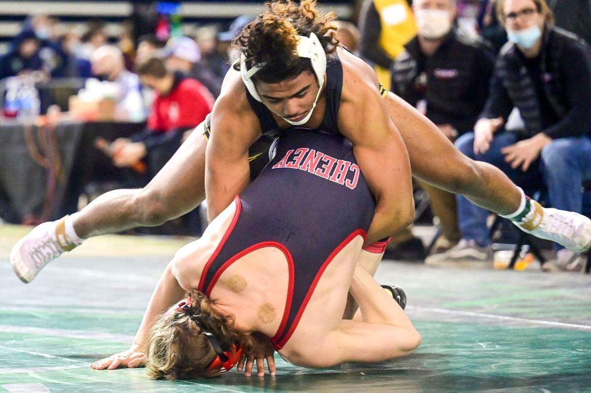 Lincoln’s Navarre Dixon gains control of the hips of Cheney’s Ezra Anderson during the first round of their 182-pound 3A quarterfinal match at Mat Classic XXXIII on Friday, Feb. 18, 2022, in Tacoma, Wash. Dixon pinned Anderson in 3 minutes, 13 seconds.