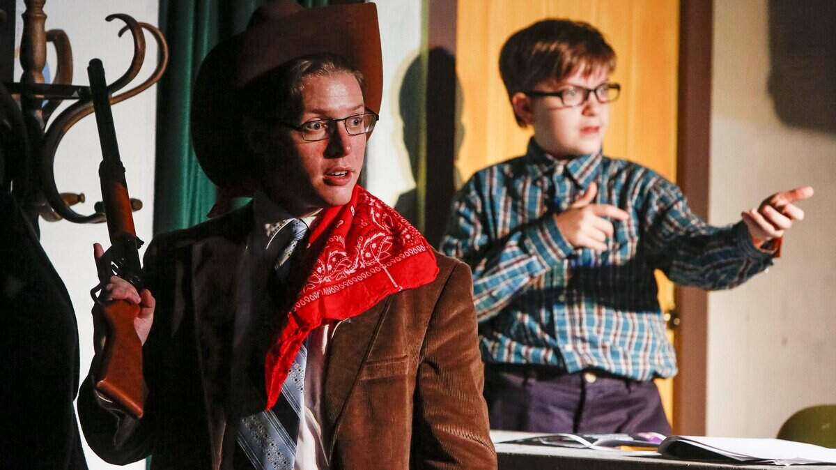 An older Ralphie, played by Michael Drake, shows off the prized Red Ryder BB gun while mimicked by a younger Ralphie, played by Ethan Edwards, during a dress rehearsal for “A Christmas Story” at Paradise Theater in Gig Harbor in November 2016. The theater operators are seeking help from the City Council to keep the theater open.