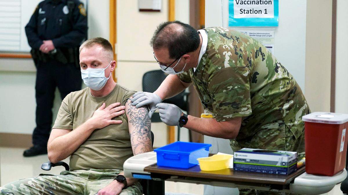 Staff Sgt. Travis Snyder, left, receives a COVID-19 vaccination at Madigan Army Medical Center, Wednesday, Dec. 16, 2020. Madigan is one of many military hospitals with a large number of vacancies. (AP Photo/Ted S. Warren)