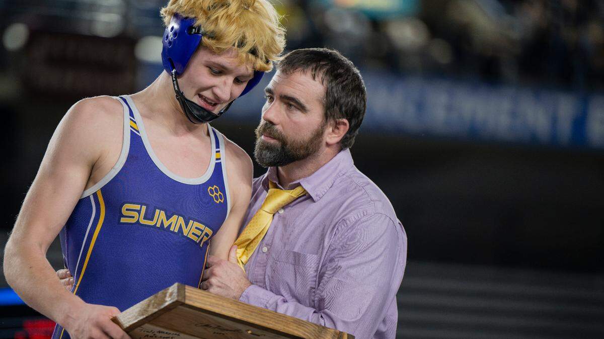 Sumner’s Cody Miller shares a moment with head coach Matt Harshman after finish his high school wrestling career undefeated and with a win in the 157-pound 4A championship during day two of the Mat Classic XXXV at the Tacoma Dome on Saturday, Feb. 17, 2024, in Tacoma, Washington.