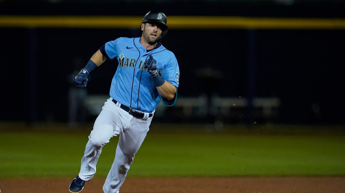 Seattle Mariners’ Mitch Haniger runs past second base with a stand-up triple in the sixth inning of a spring training baseball game against the Chicago White Sox, Friday, March 19, 2021, in Peoria, Ariz. (AP Photo/Sue Ogrocki)