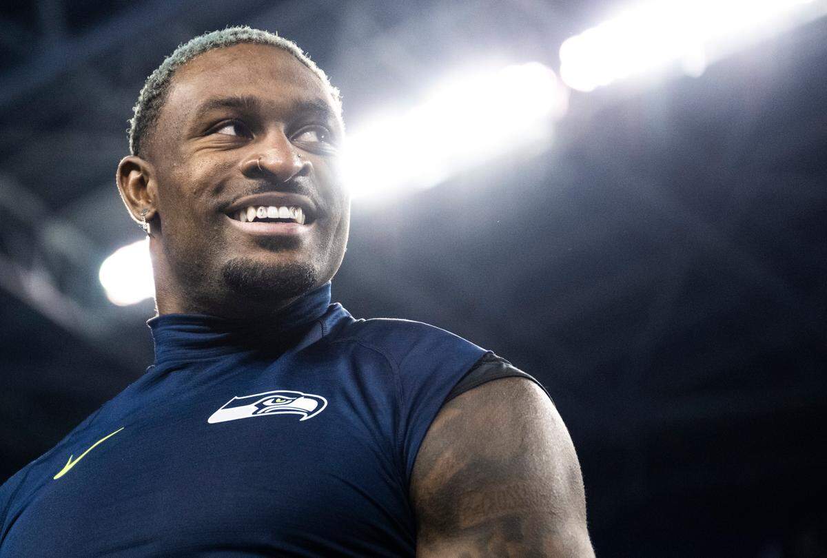 Seattle Seahawks wide receiver DK Metcalf (14) smiles as he talks to San Francisco 49ers players on the field after an NFL game at Lumen Field in Seattle Wash. on Dec. 15, 2022.