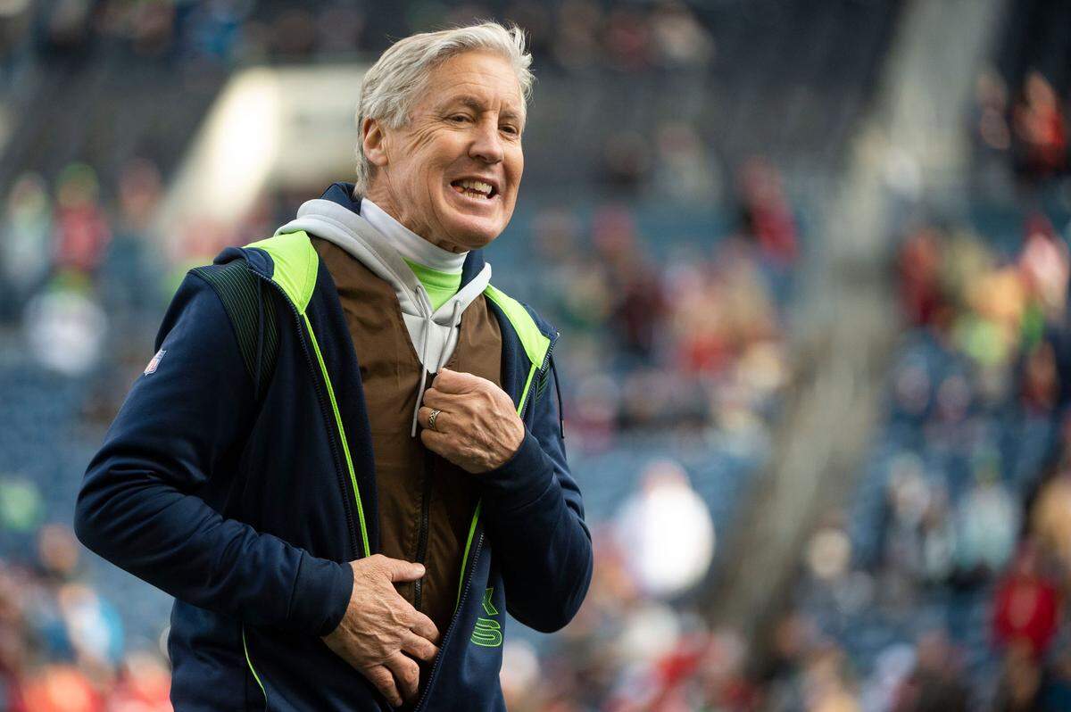 Seattle Seahawks head coach Pete Carroll talks to players prior to the start of an NFL game against the San Francisco 49ers on Sunday at Lumen Field in Seattle.