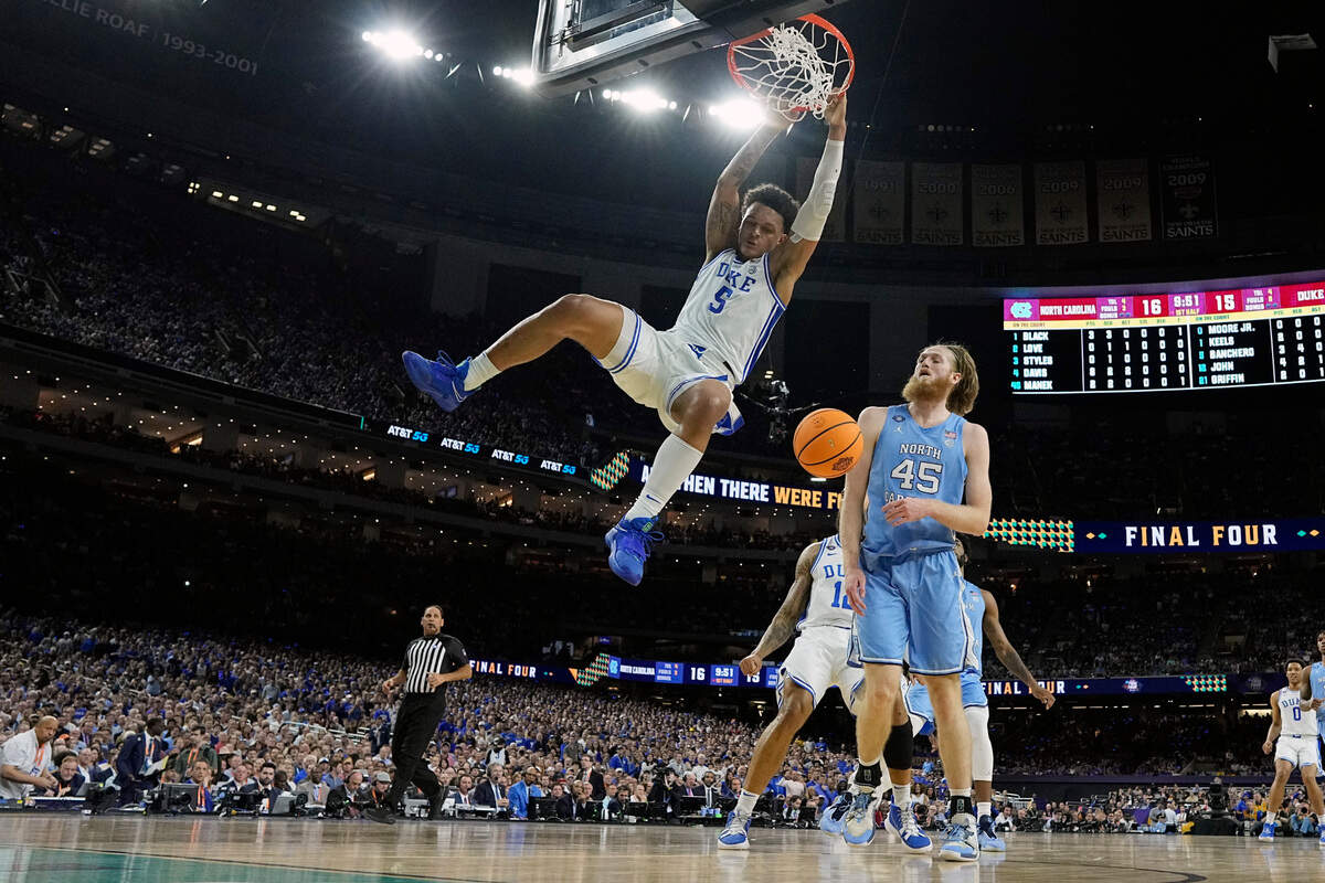 Duke forward Paolo Banchero (5) dunks ahead of North Carolina’s Brady Manek (45) during the first half of a college basketball game in the semifinal round of the Men’s Final Four NCAA tournament, Saturday, April 2, 2022, in New Orleans. (AP Photo/David J. Phillip)