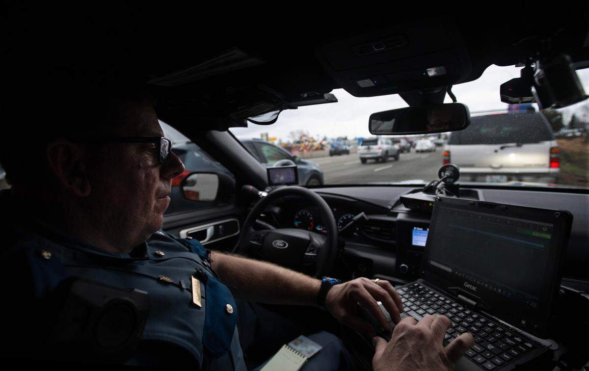 Washington State Patrol Trooper Shannon McKenzie writes a citation for a driver accused of using the HOV lane to skip a line of vehicles waiting at an on-ramp light on Interstate 5 through Fife, Washington, on Tuesday, Feb. 27, 2024. McKenzie says the number one complaint WSP receives from the public is about HOV lane violators.