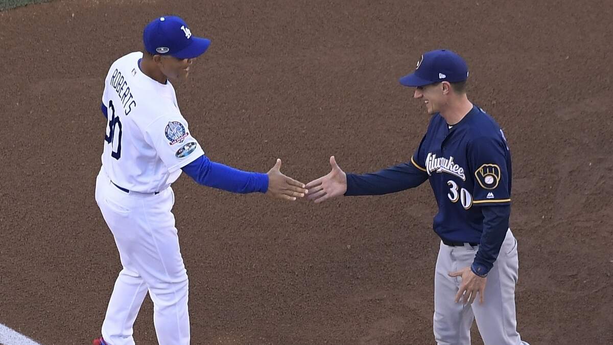 Milwaukee Brewers manager Craig Counsell and Los Angeles Dodgers manager Dave Roberts shake hands before Game 3 of the National League Championship Series baseball game Monday, Oct. 15, 2018, in Los Angeles. (AP Photo/Mark J. Terrill)