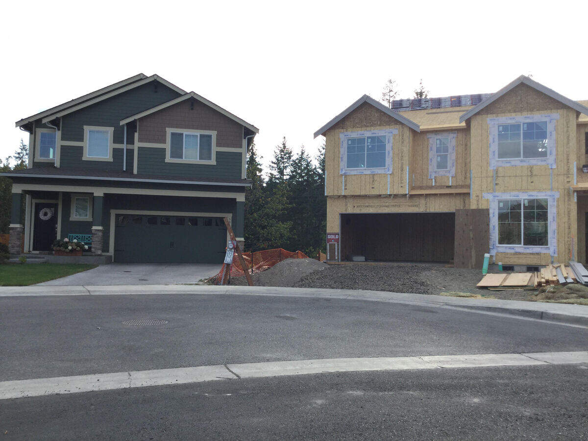 A house under construction sits in contrast to a fully-build, occupied home in the McCormick Creek neighborhood in Gig Harbor. McCormick Creek residents have been working with the city after finding out a development agreement from 2017 may force them to pay for a public parking lot.