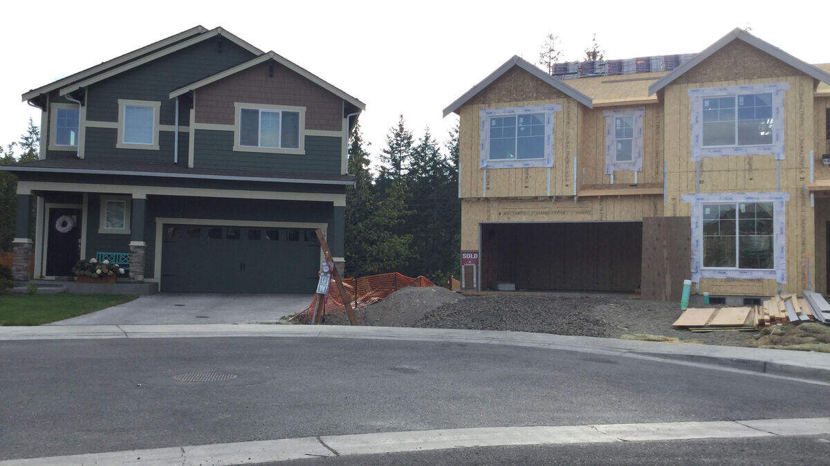 A house under construction sits in contrast to a fully-build, occupied home in the McCormick Creek neighborhood in Gig Harbor. McCormick Creek residents have been working with the city after finding out a development agreement from 2017 may force them to pay for a public parking lot.