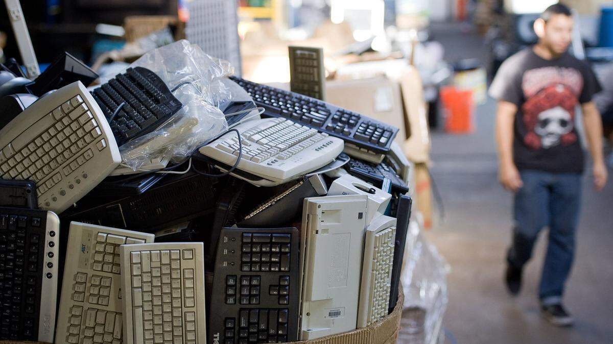 Old computer keyboards fill a box at a recycling company in Santa Ana, Calif., in 2013.