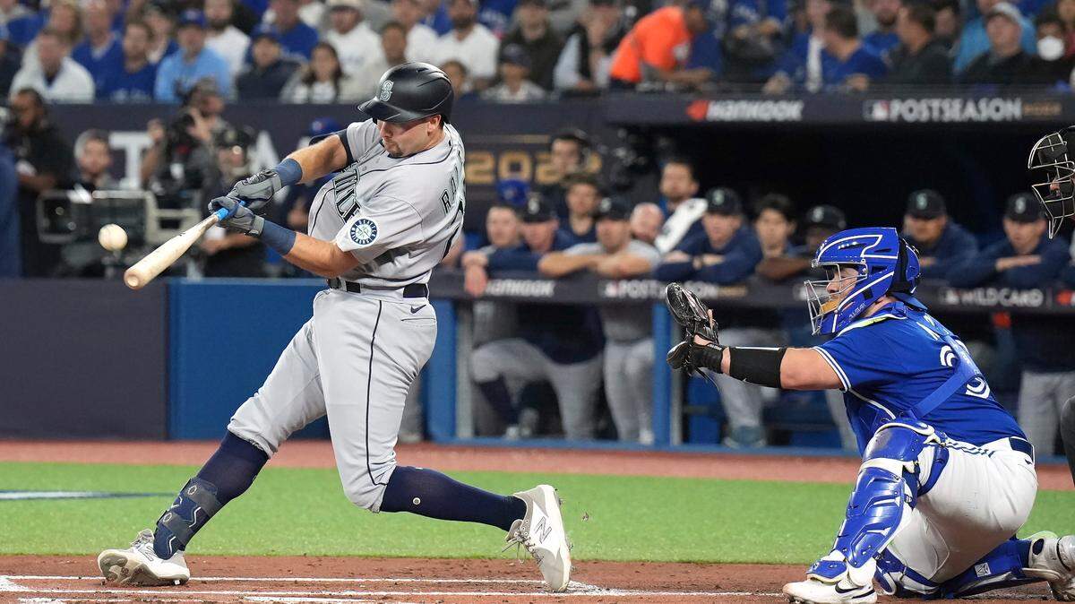Seattle Mariners Cal Raleigh (29) hits a two-run home run during the first inning s of Game 1 in a AL wild card baseball playoff series against the Toronto Blue Jay in Toronto on Friday, Oct. 7, 2022. (Nathan Denette/The Canadian Press via AP)