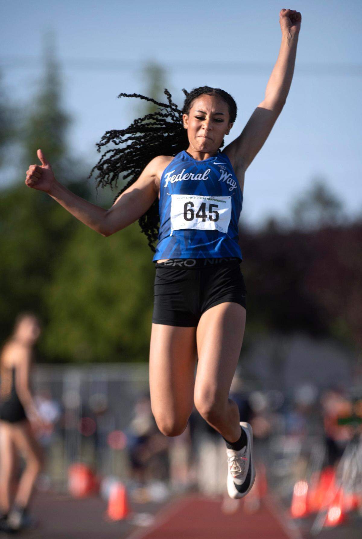 Federal Way’s Cassandra Atkins leaps en route to the 4A girls triple jump state title during the opening day of the WIAA state track and field championships at Mount Tahoma High School in Tacoma, Washington, on Thursday, May 25, 2023.