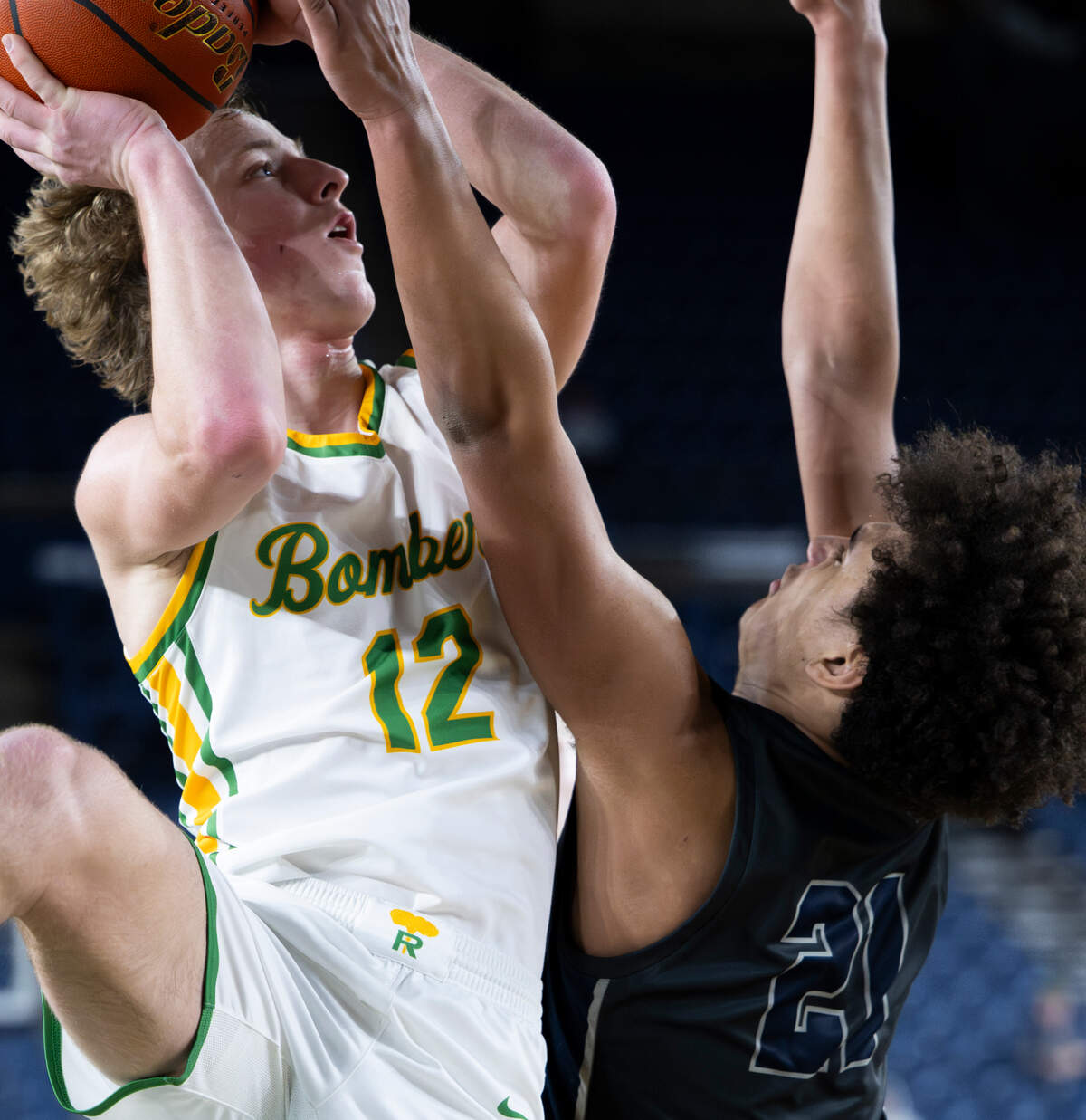Richland’s Joshua Woodard (12) goes up high for a shot over Glacier Peak’s Jayce Nelson (21) during the semifinals game of the Class 4A state tournament at the Tacoma Dome, on Friday, March 1, 2024, in Tacoma, Wash.