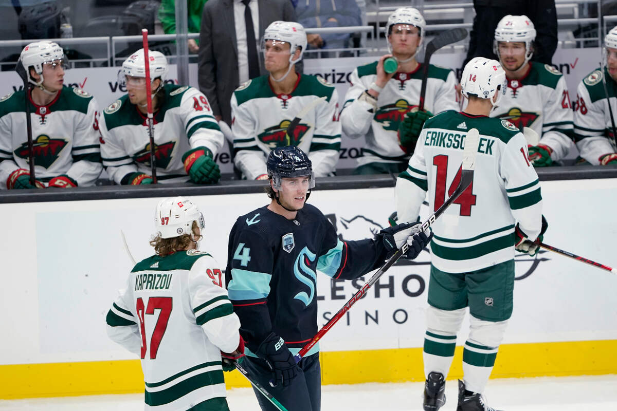 Seattle Kraken defenseman Haydn Fleury (4) skates in front of the Minnesota Wild bench after his second goal of the night, during the second period of an NHL hockey game Thursday, Oct. 28, 2021, in Seattle. (AP Photo/Ted S. Warren)