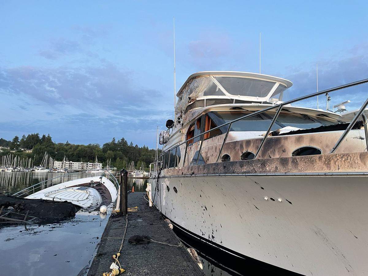 A boat fire early Friday morning at the Gig Harbor Marina and Boatyard burned and partially sank one 80-foot boat (left), according to Gig Harbor Fire & Medic One. Another large boat (right) took moderate exterior damage.