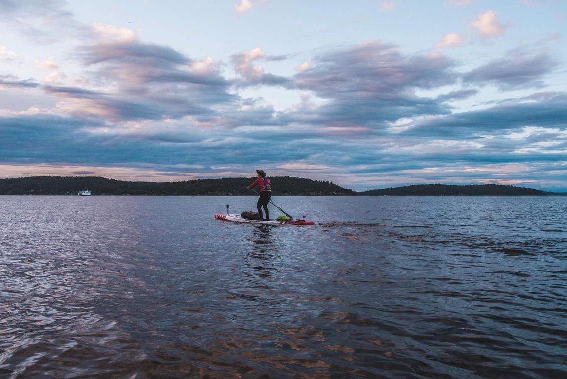 Jeannine Mackie paddling at sunset.