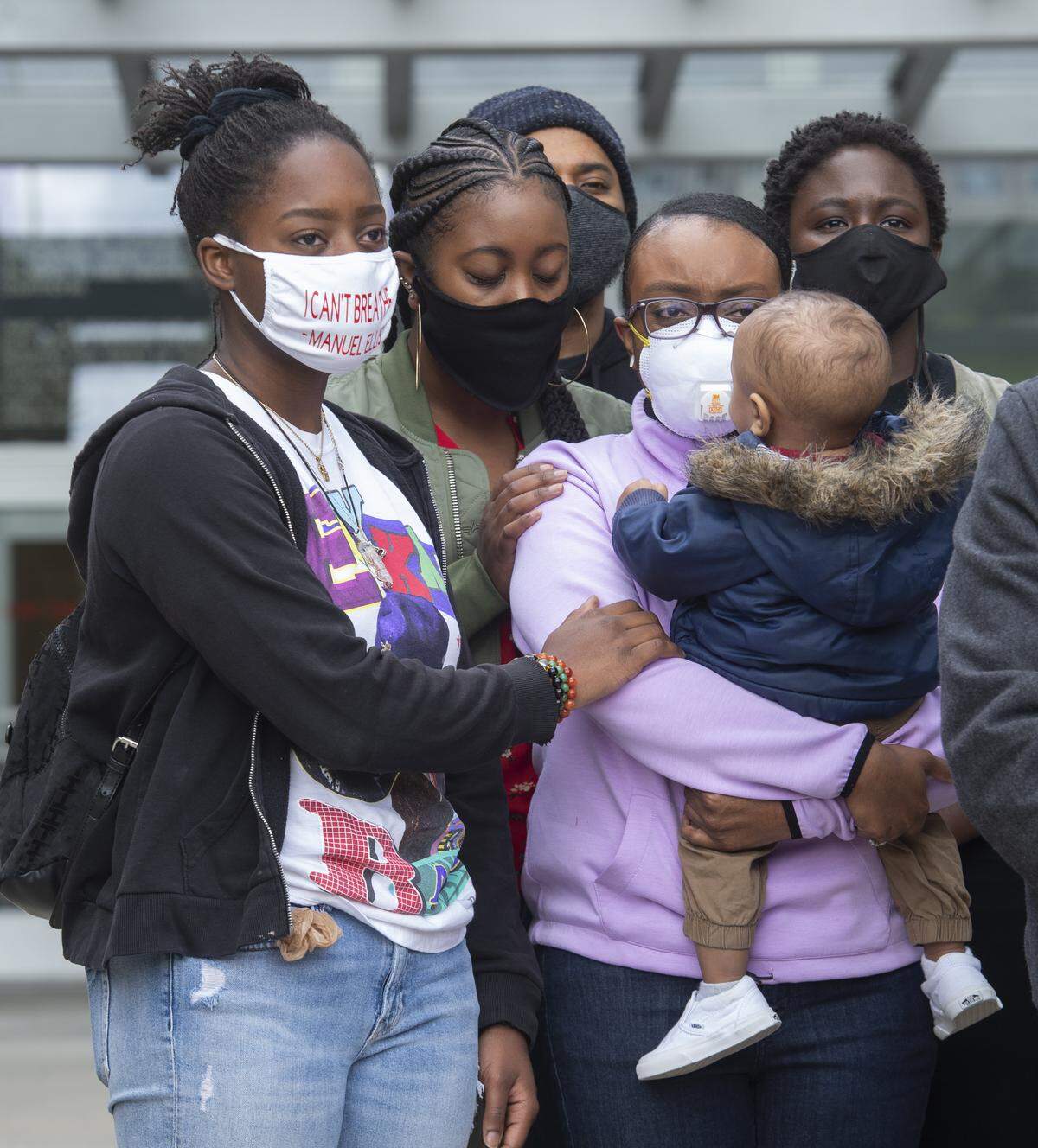 Monet Carter-Mixon, right, sister of Manuel Ellis, holds her son while being comforted by Vanessa Bussell, left, and Jamika Scott at a press conference outside Tacoma’s County-City Building on Thursday, June 4, 2020. The family, friends and black leaders are calling for justice in the Ellis case. The Pierce County Medical Examiner ruled Ellis died due to respiratory arrest due to physical restraint.
