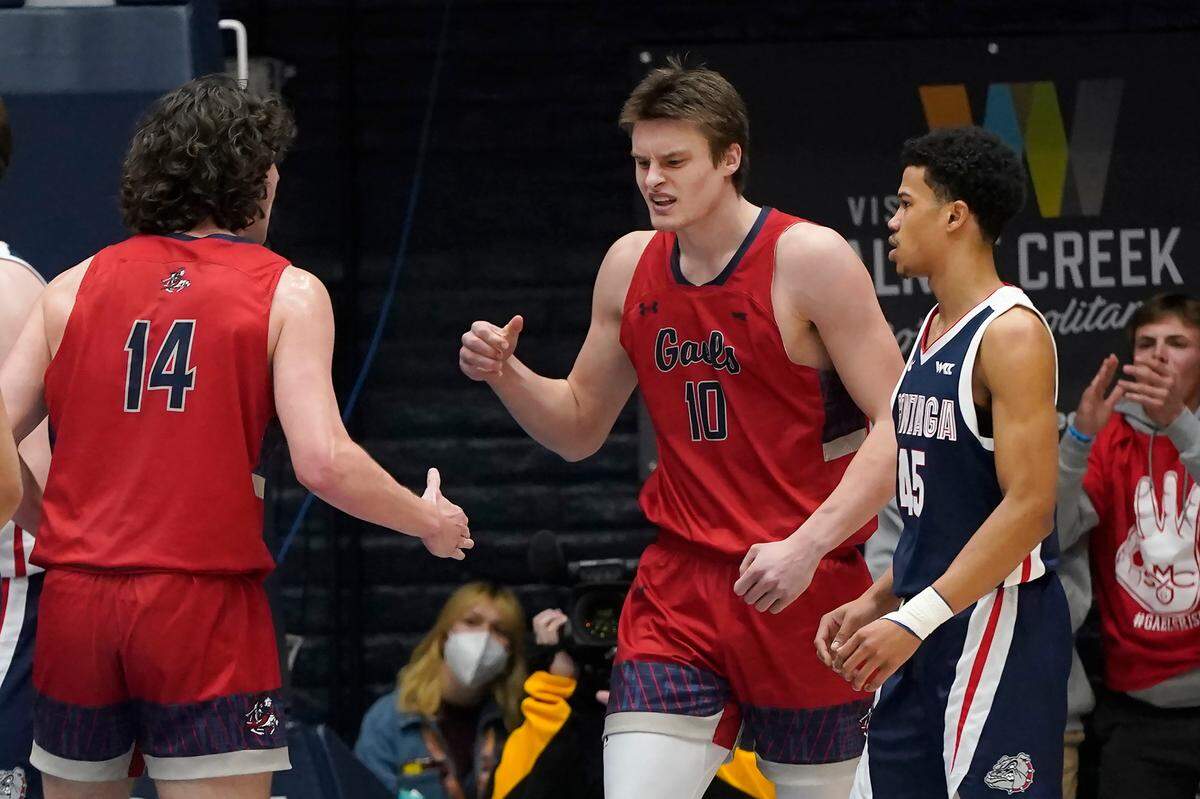 Saint Mary’s center Mitchell Saxen (10) celebrates with forward Kyle Bowen (14) after scoring next to Gonzaga guard Rasir Bolton during the first half of an NCAA college basketball game in Moraga, Calif., Saturday, Feb. 26, 2022. (AP Photo/Jeff Chiu)