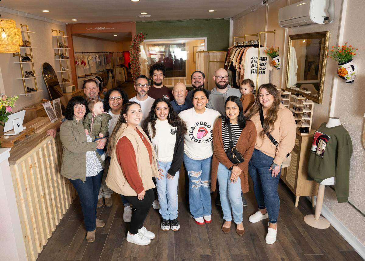 Owner Bianca Hernandez (front row, third from left) poses for a portrait with family at Nuestro Barrio, on Wednesday, May 1, 2024, in Puyallup, Wash.