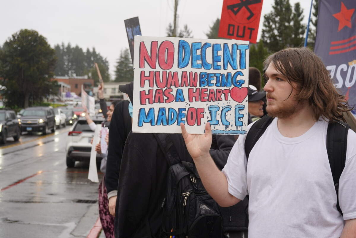 Students held up signs criticizing U.S. Immigration and Customs Enforcement at a walkout from Gig Harbor High School downtown, Friday, Feb. 13, 2026.