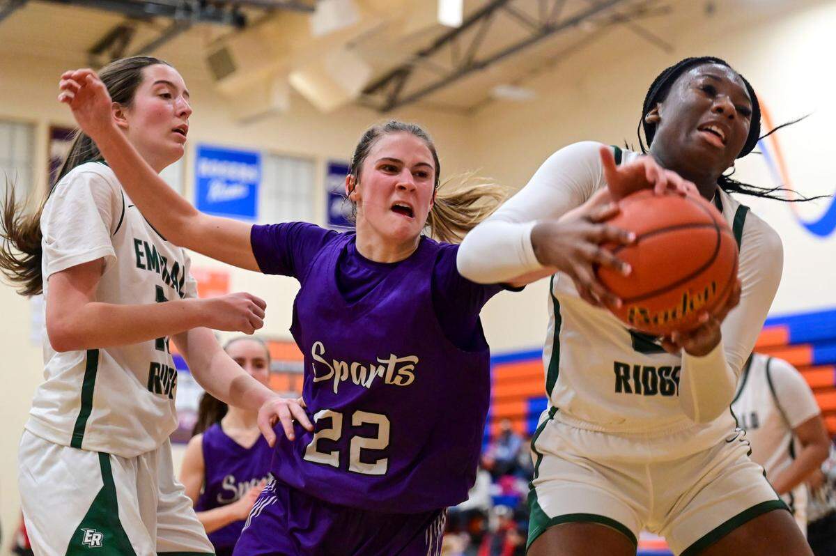 Sumner guard Lainee Houilan (22) and Emerald Ridge guard Kali Haizlip (2) battle for a rebound during the second quarter of a 4A South Puget Sound League tournament championship game on Saturday, Feb. 5, 2022, at Graham-Kapowsin High School in Graham, Wash.