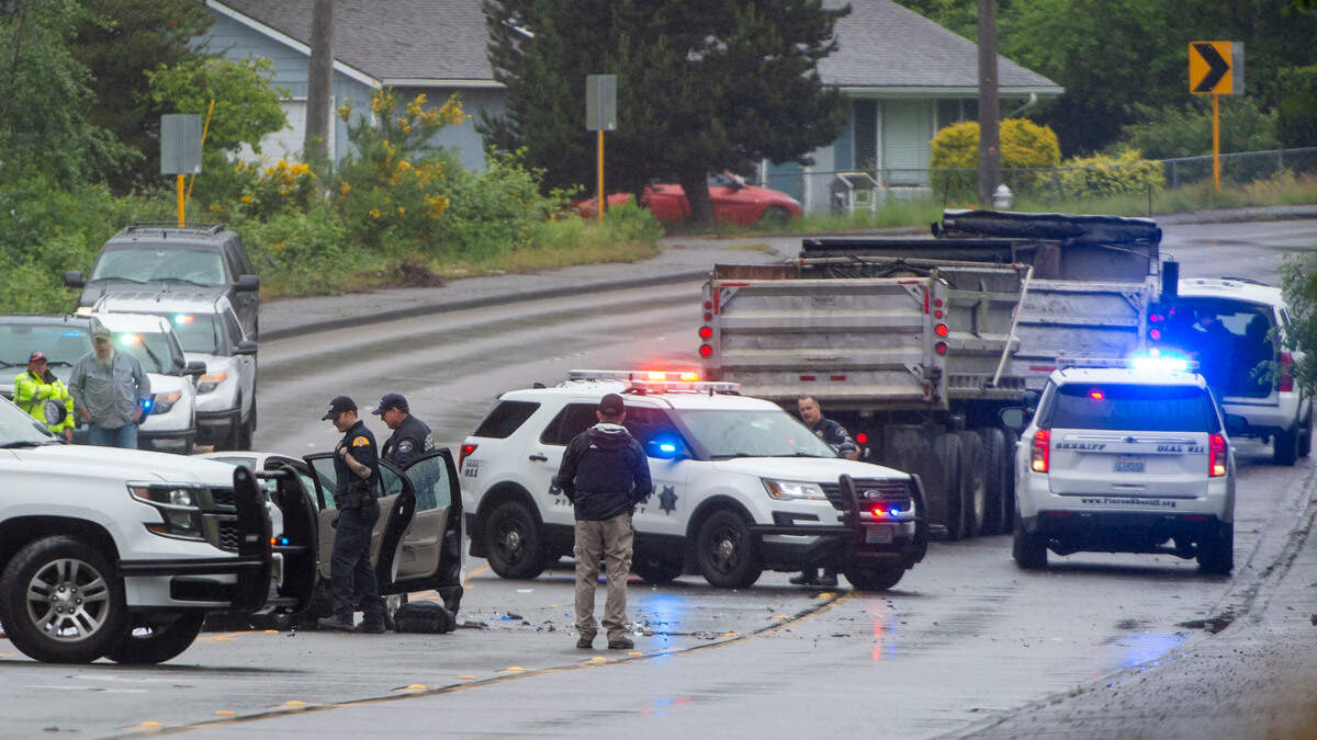 Deputies from the Pierce County Sheriff’s Department investigate the scene of a fatal vehicle accident near the intersection of Spanaway Loop Road and 158th Street on Thursday, June 9, 2022, in Spanaway.