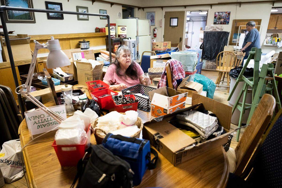Pat Cantrell, 73, sorts through and organizes a pile of silverware to help pack the belongings of the Spana-Park Senior Center, which is being evicted from its Parkland home. Cantrell has been visiting the center two times a week for five years to attend a quilting class, where she says, “We had a ball being together and doing things together.”