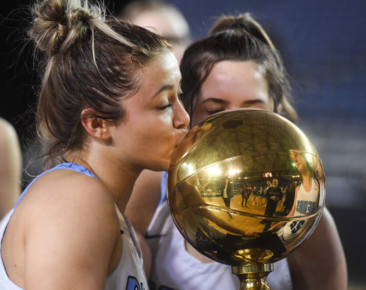 Central Valley’s Peyton Howard kisses the trophy after the game. Woodinville played Central Valley in the 4A girls championship game at the Hardwood Classic state basketball tournament at the Tacoma Dome in Tacoma, Wash., on Saturday, March 7, 2020.