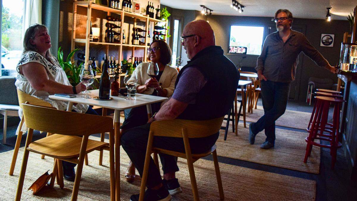 Cuvée Wine Bar focuses on wines you can’t find elsewhere in the area, enjoyed in an intimate setting at 3019 Judson St. in Gig Harbor. Co-owner Jake Snider chats with regulars Wendy Carr (on left) with Soledad and Jeff Thesman on Thursday, Sept. 19, 2024.