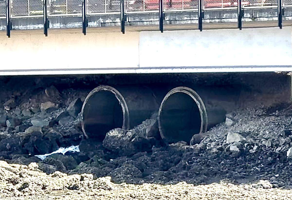A pair of storm drains empty water into the Foss Waterway underneath Dock Street on Thursday, May 30, 2024.