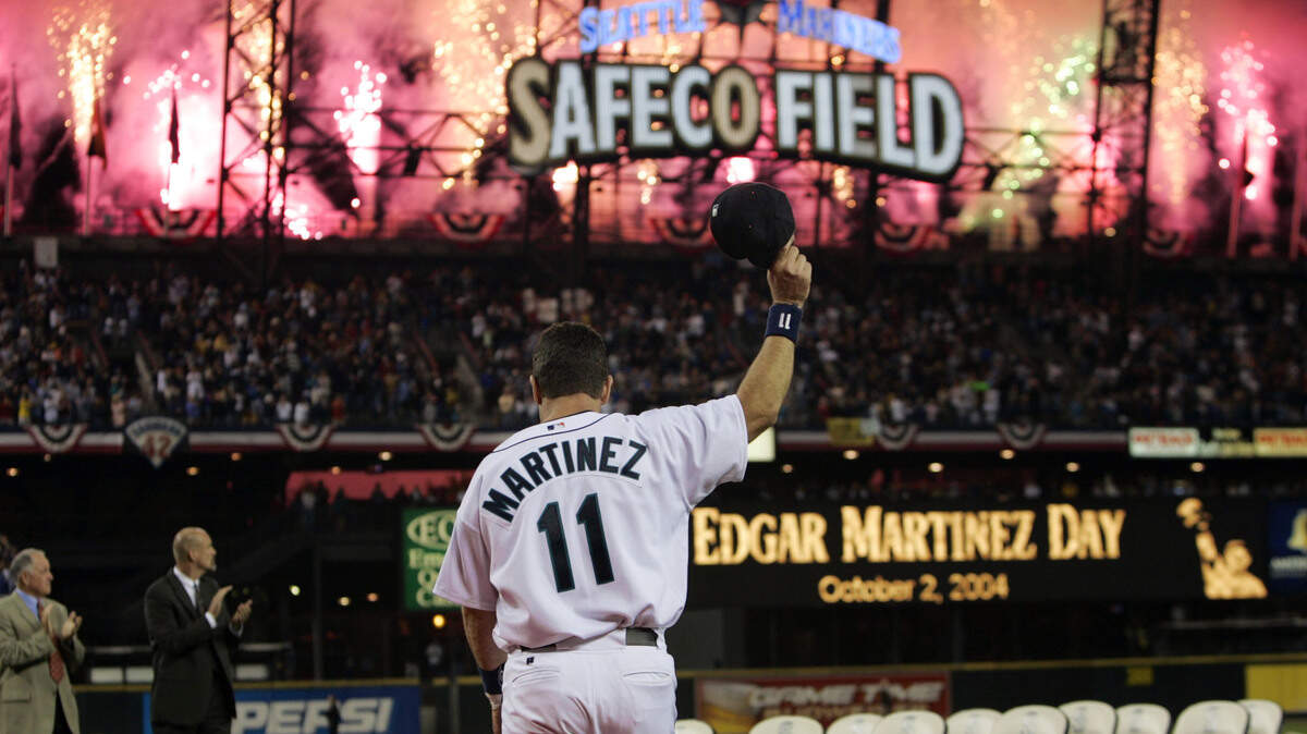 Seattle Mariners’ Edgar Martinez waves his cap as fireworks go off, while he is introduced at a post-game ceremony, Saturday, Oct. 2, 2004, in Seattle. They sure love Martinez in Seattle. On the eve of his final game in the majors, the Mariners’ retiring designated hitter was honored with a lengthy postgame tribute Saturday night after Seattle’s 10-4 loss to the Texas Rangers. (AP Photo/Elaine Thompson)