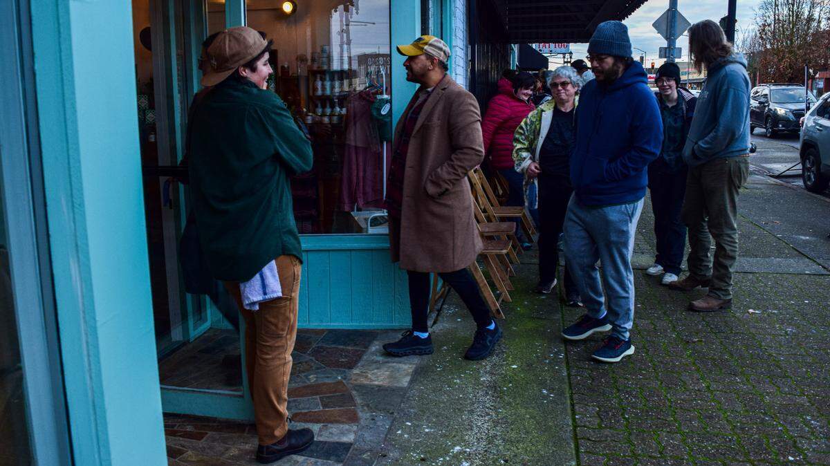 Howdy Bagel reopened at 5421 South Tacoma Way on Wednesday, Feb. 7, 2024, following the tragic death of co-owner Jacob Carter. An employee opened the door at 8 a.m., welcoming the first customer, Shaynedonovan Elliott, center.