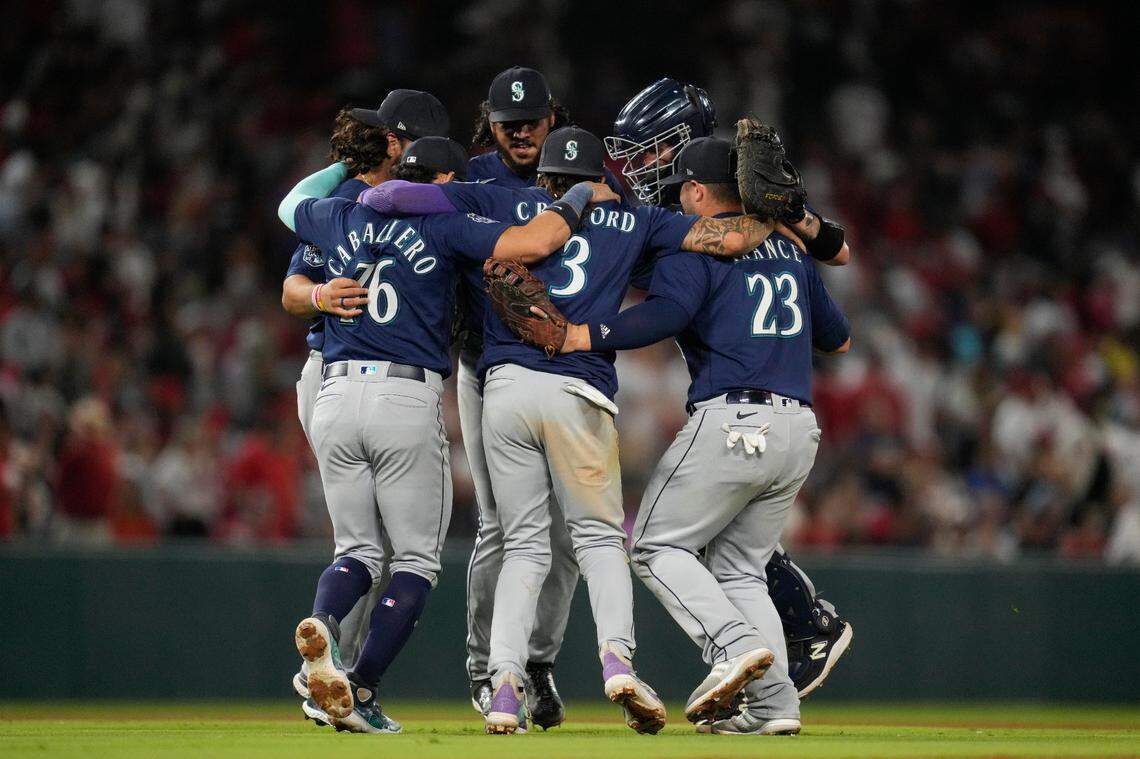 The Seattle Mariners celebrate after a 3-2 win over the Los Angeles Angels in a baseball game in Anaheim, Calif., Saturday, Aug. 5, 2023. (AP Photo/Ashley Landis)