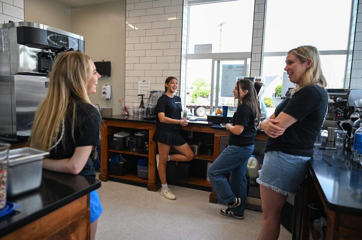 Employees The Mount Rainier Creamery & Market chat and joke during slow portion of their day on Friday, Aug. 2, 2024 in Buckley.