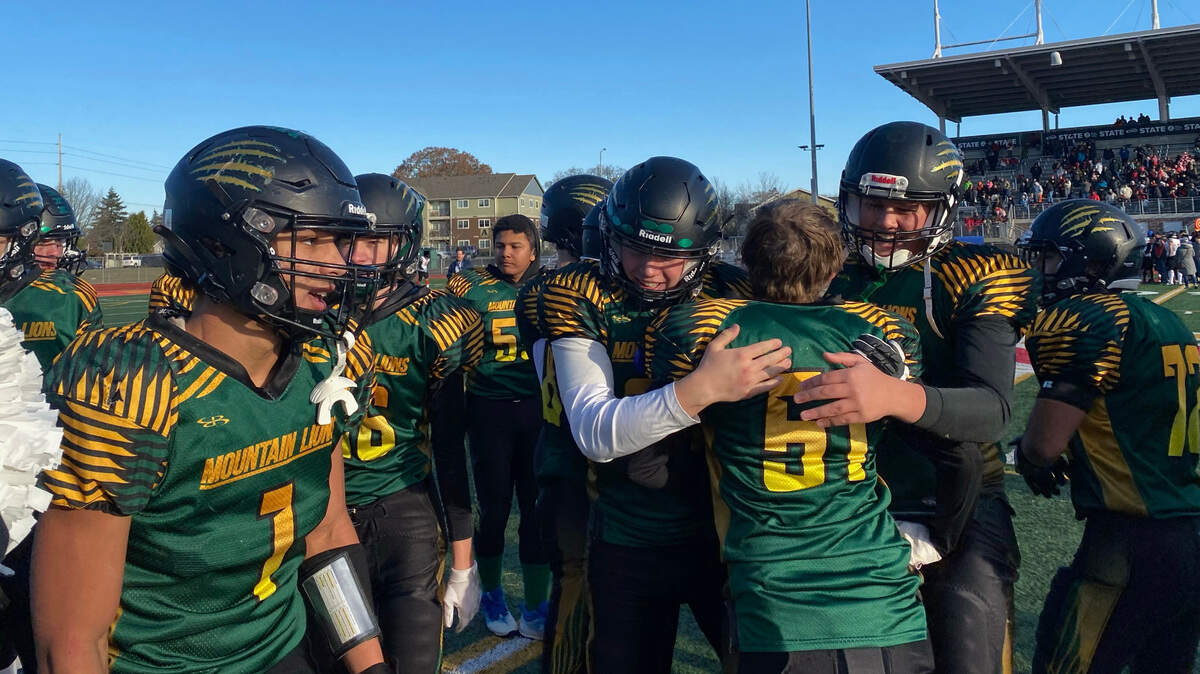 Liberty Bell High School football players celebrate following a 50-12 win over Neah Bay in the Class 1A state championship game on Saturday, Dec. 3, 2022 at Mount Tahoma Stadium in Tacoma, Wash. (Tyler Wicke/The News Tribune)