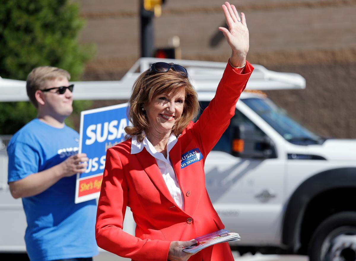 In this Sept. 17, 2018 photo, Republican U.S. Senate candidate Susan Hutchison waves as she campaigns outside a Boeing plant in Renton, Wash. Hutchison, who spent two decades as a Seattle TV news anchor before leading the state GOP party for five years, is running against Democratic incumbent Sen. Maria Cantwell.