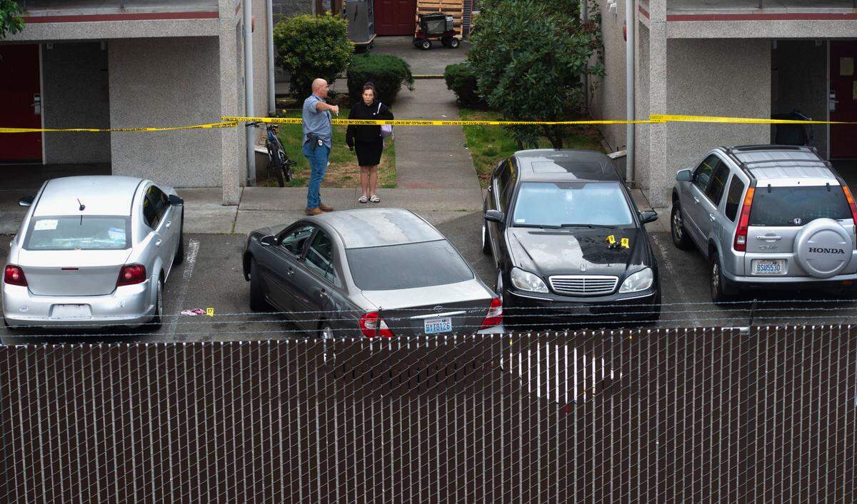Tacoma police investigate the scene where Antonio Robinson was found fatally shot Sept. 23, 2021, in the parking lot of the Econo Lodge on South Hosmer Street.