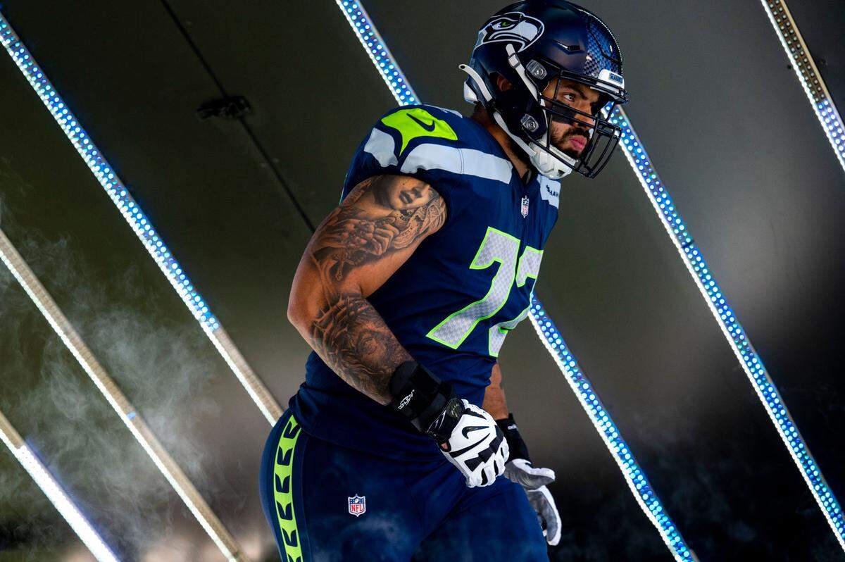 In this Sept. 25, 2022, file photo, Seattle offensive lineman Abraham Lucas jogs onto the field during pre-game introductions prior to the start of an NFL game against the Atlanta Falcons on Sunday, Sept. 25, 2022, at Lumen Field in Seattle.