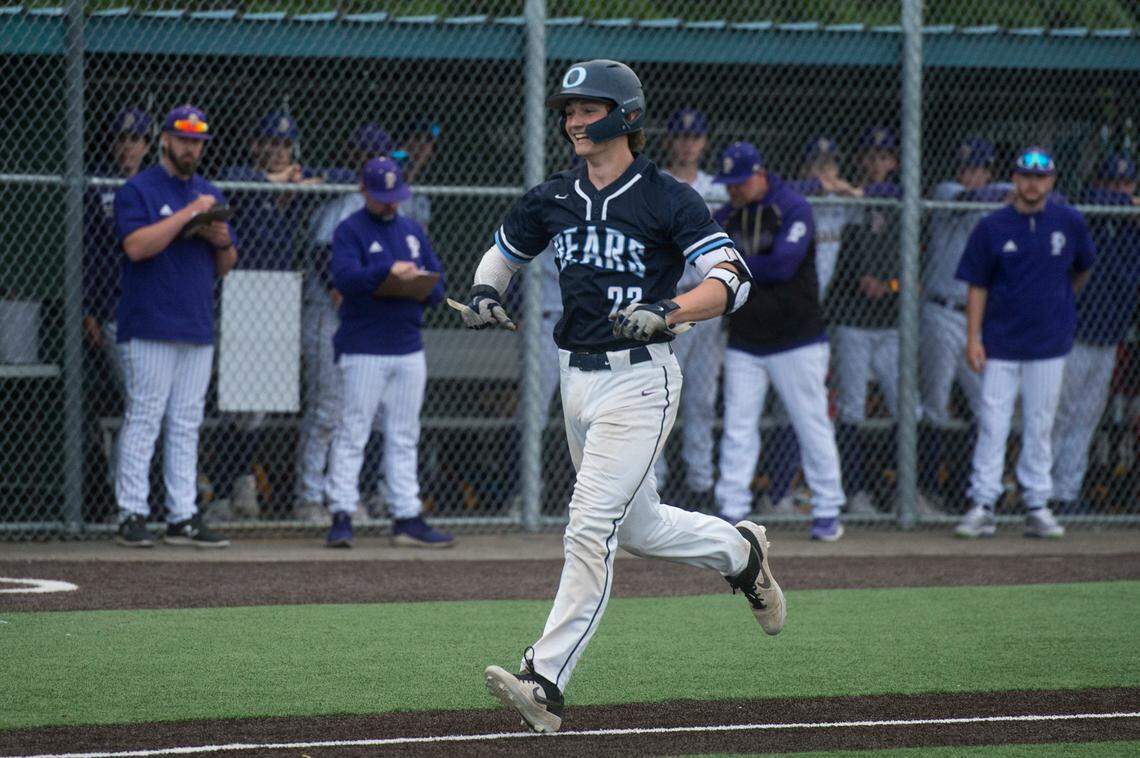 Olympia High School infielder Logan Shepherd celebrates hitting a two-run home run in the second inning of the Class 4A West Central/Southwest bidistrict championship game on Saturday, May 14, 2022 at Kent-Meridian High School in Kent, Wash. Olympia beat Puyallup, 8-4, to win the title.
