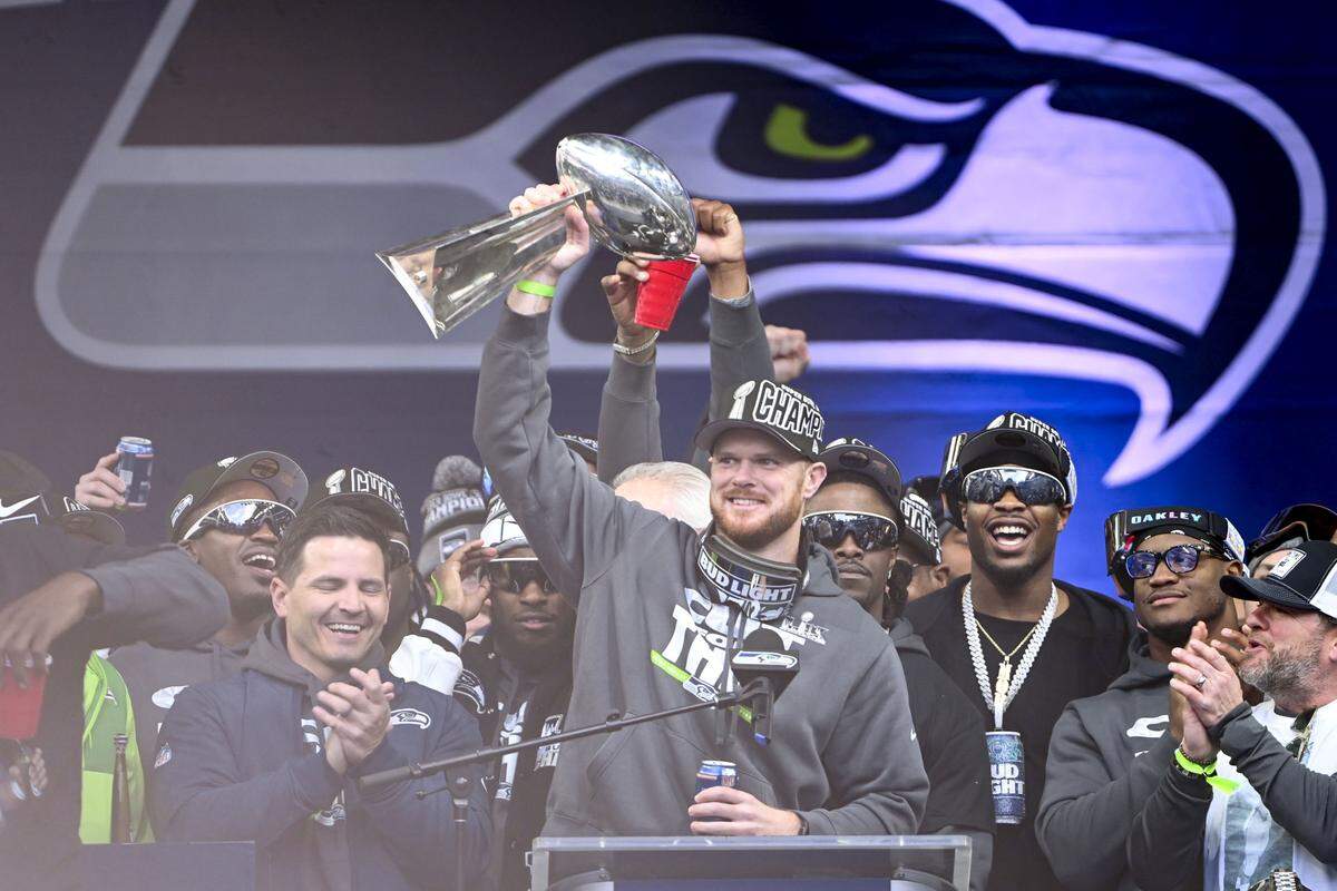 Seattle Seahawks quarterback Sam Darnold raises the Lombardi Trophy during the team’s Trophy Celebration event at Lumen Field on Wednesday, Feb. 11, 2026, in Seattle.