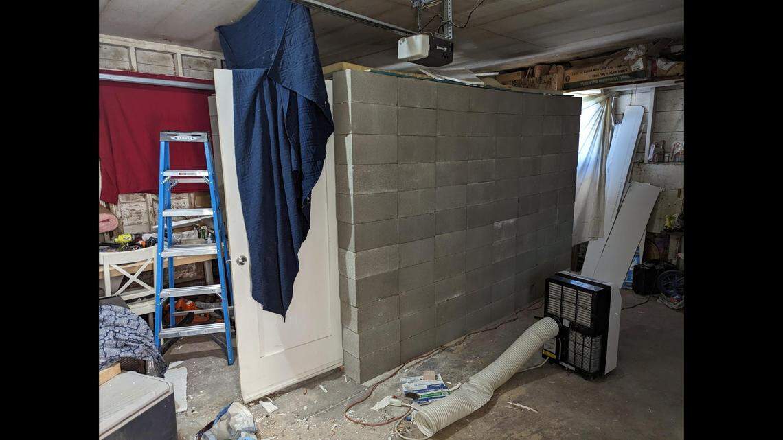 The “makeshift cell” was made of cinder blocks with “a metal door installed in reverse so it could not be opened from the inside,” according to court documents.