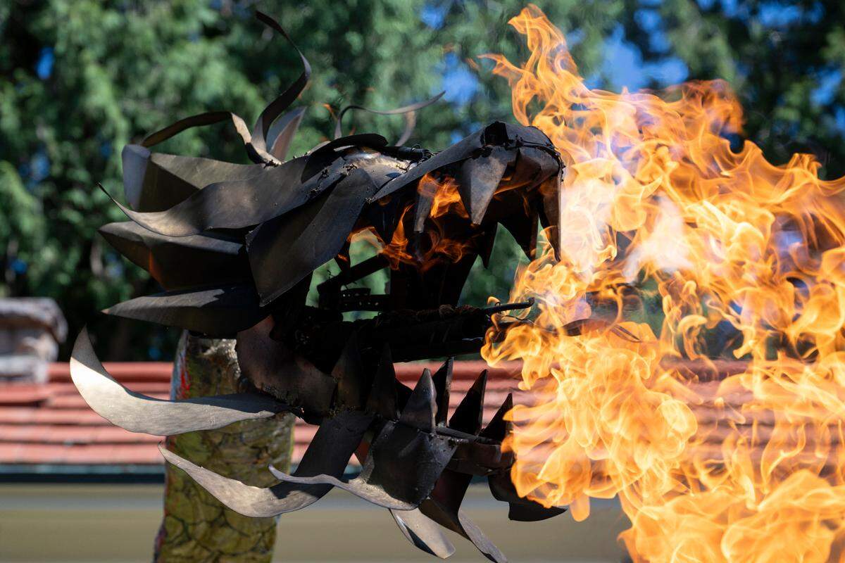 Flames spew out of the mouth of Steve LaBerge’s dragon, which will make its annual appearance at the Tacoma Porchfest parade, as he operates the creation in his driveway on Monday, July 7, 2025, in Tacoma.