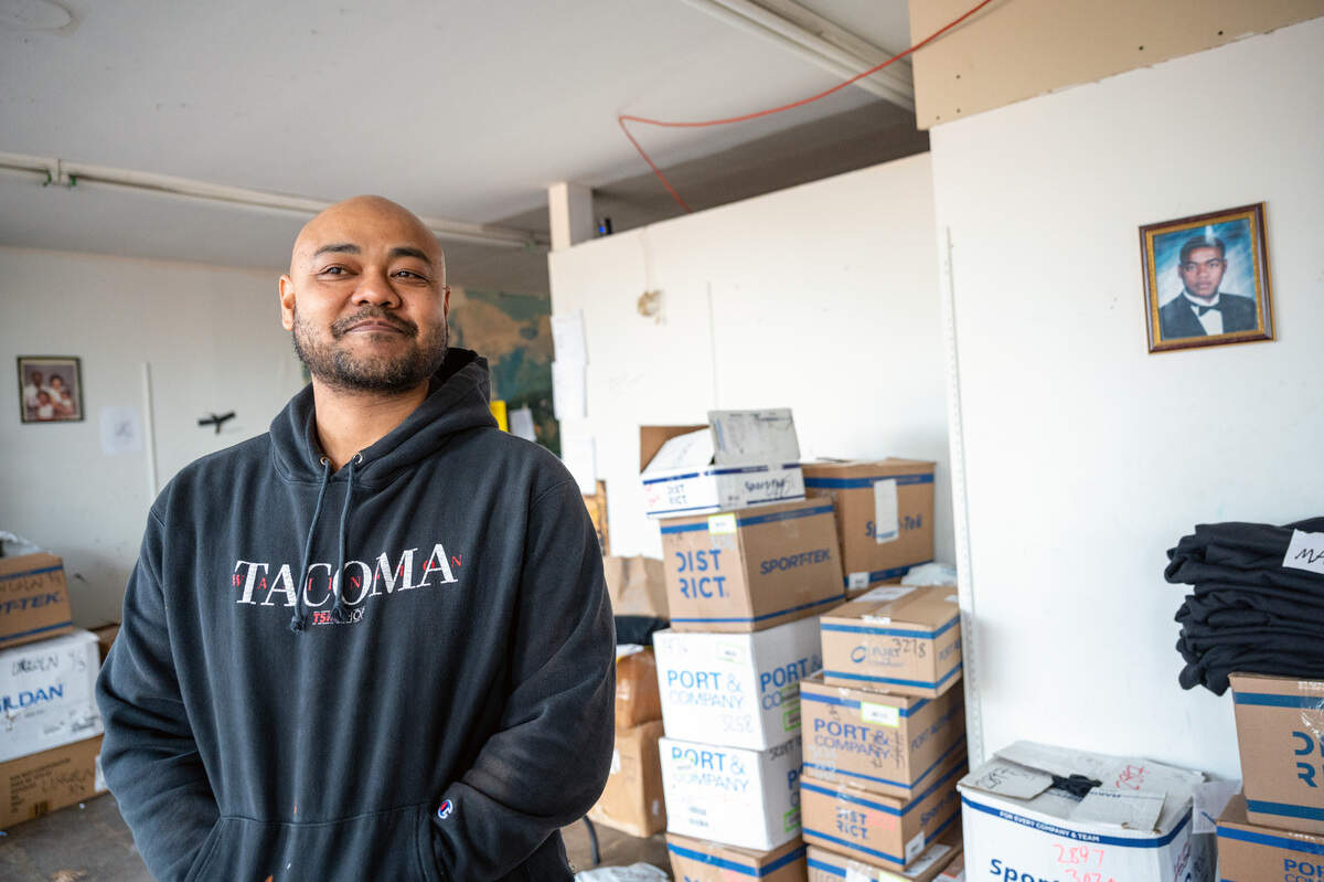 Willie Combs, the owner The TSM Shop, stands inside his custom T-shirt store, where he has had multiple broken windows and the theft of some of his merchandise.