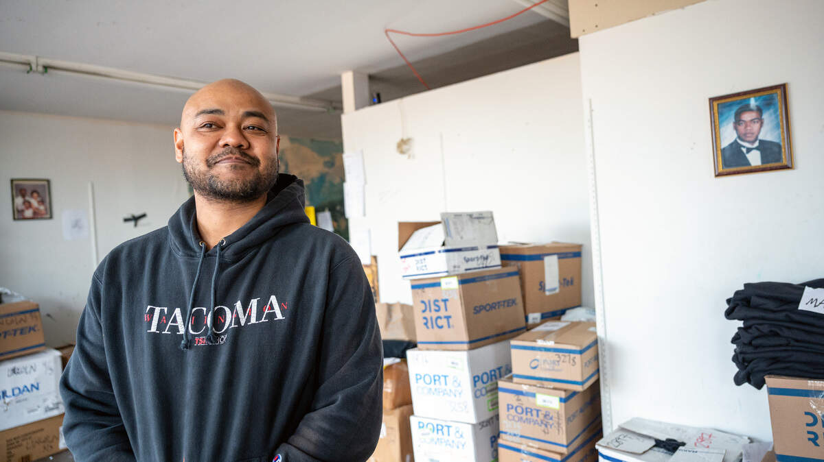 Willie Combs, the owner The TSM Shop, stands inside his custom T-shirt store, where he has had multiple broken windows that included the theft of some of his merchandise.