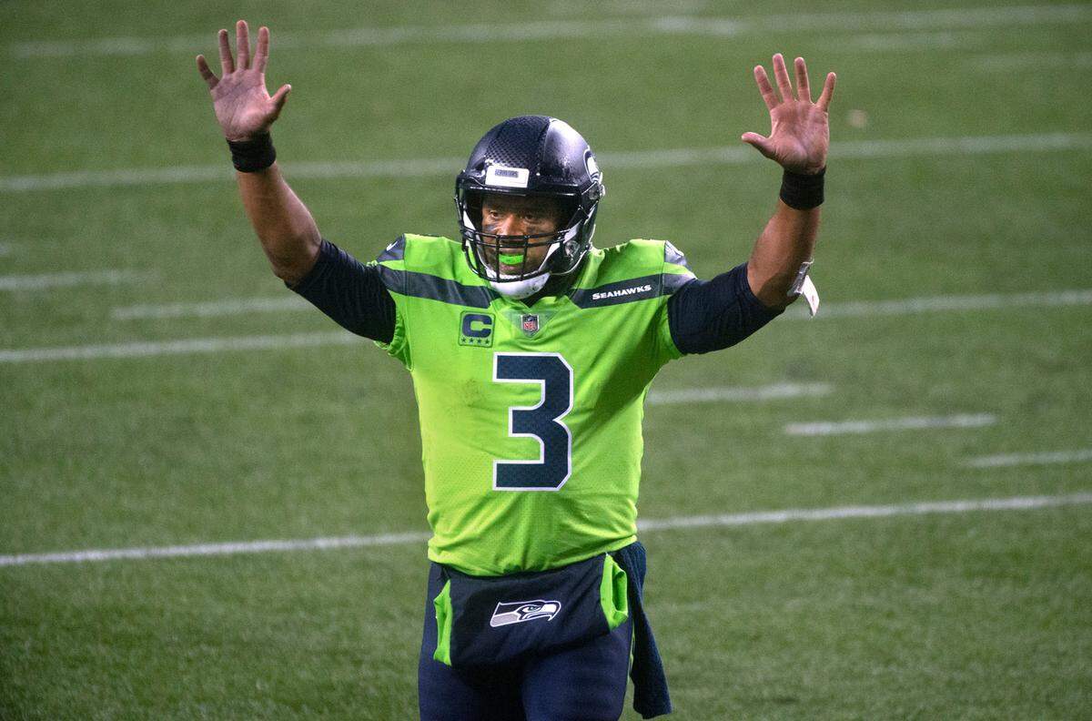 Seattle Seahawks quarterback Russell Wilson signals touchdown after a complete pass at the goalline to DK Metcalf set up the game-winning touchdown during Sunday night’s NFL football game at Centurylink Field in Seattle, Washington, on Sunday, Oct. 11, 2020.